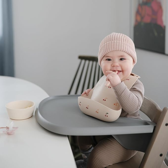 mushie Silicone Baby Bib | Adjustable Fit Waterproof Bibs (Cherries)